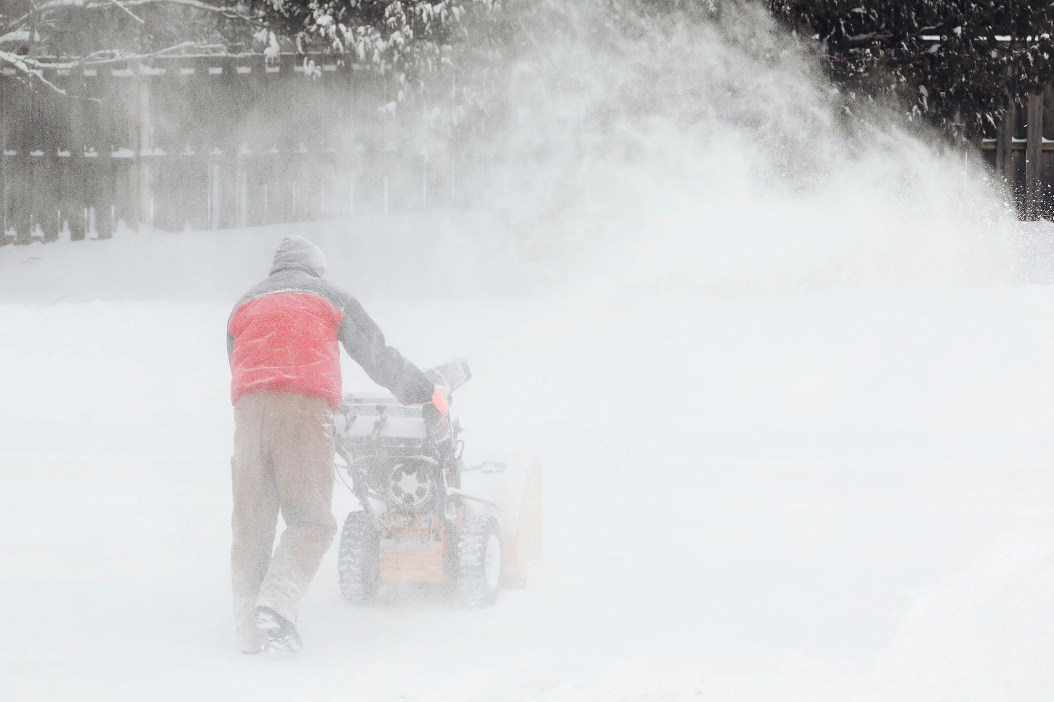 Man removing snow with a snowblower